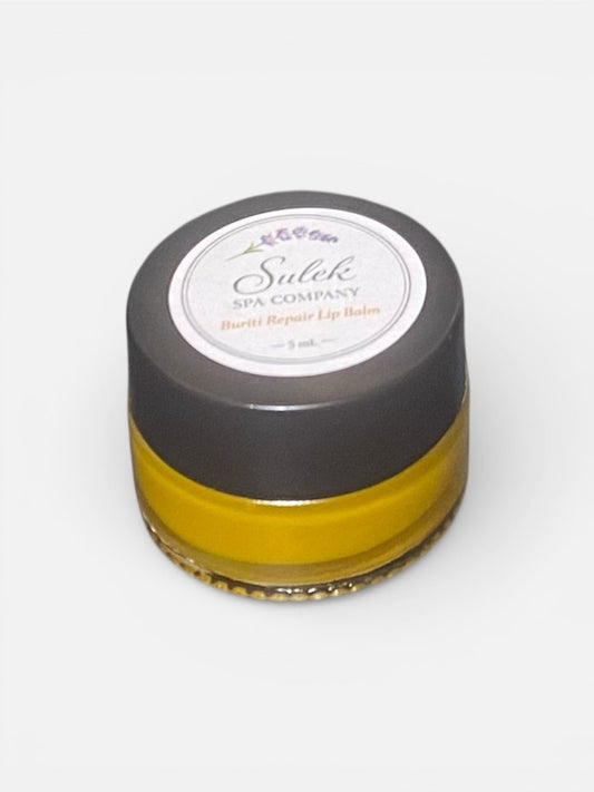 Buriti Repair Lip Balm in a closed glass jar, an unscented nourishing lip balm formulated with buriti oil for smooth, hydrated lips Sulek Spa Company